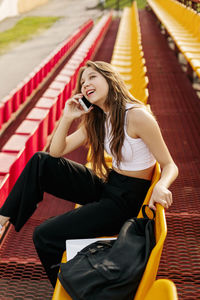 Portrait of young woman sitting on staircase