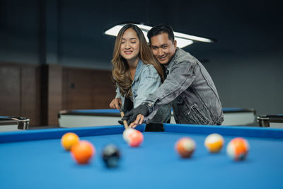 Portrait of woman playing pool