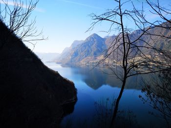 Scenic view of lake and mountains against sky