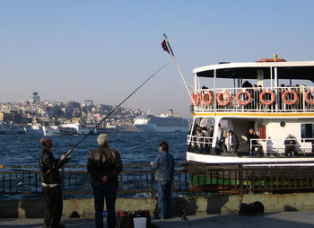 Passenger boat at harbor with city in background