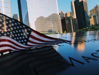 Close-up of american flag in city