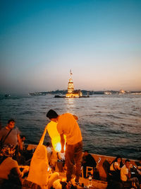 View of statue at illuminated temple against sky