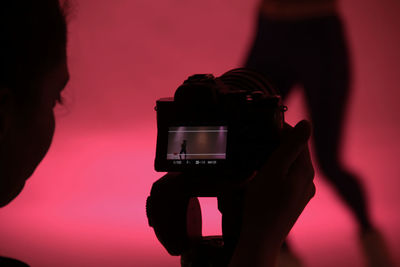 Close-up of man photographing camera