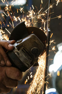 Close-up of man working on metal