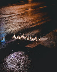 High angle view of illuminated floating on water at night