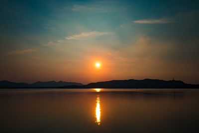 Scenic view of river against sky during sunset