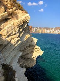 Rock formations by sea against sky