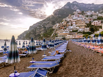 Sailboats moored on beach against sky