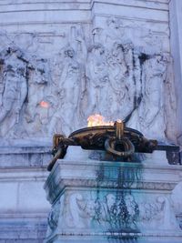 Buddha statue against historic building