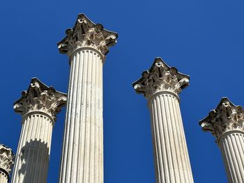 Low angle view of statue against clear blue sky