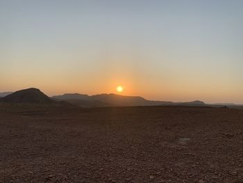 Scenic view of desert against sky during sunset