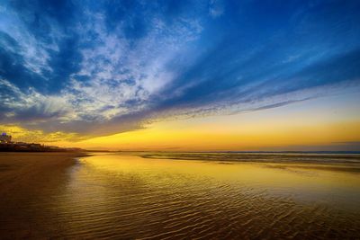 Scenic view of beach against sky during sunset