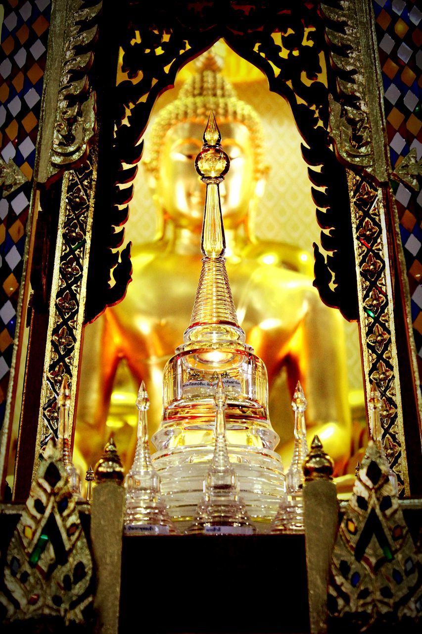 indoors, place of worship, religion, spirituality, art and craft, illuminated, low angle view, creativity, art, ornate, architecture, built structure, pattern, chandelier, church, ceiling, design, decoration, one person