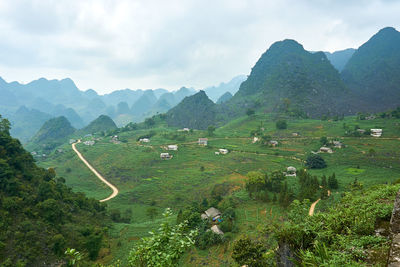 Scenic view of field and mountains against sky