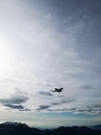 Low angle view of airplane flying against sky