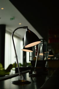 Close-up of illuminated lamp on table