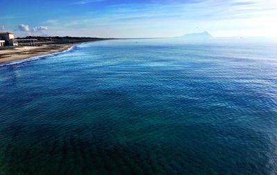 Scenic view of sea against blue sky