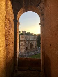 Arch of constantine viewed from inside the colosseum in rome 