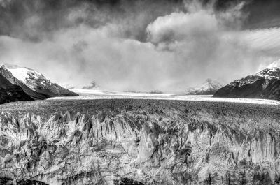 Idyllic shot of perito moreno glacier and mountains against cloudy sky