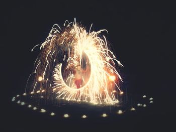 Close-up of illuminated fireworks against sky at night