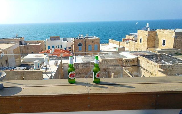 sea, horizon over water, water, architecture, built structure, building exterior, clear sky, high angle view, house, day, blue, sky, railing, beach, residential building, outdoors, residential structure, nature, no people, sunlight