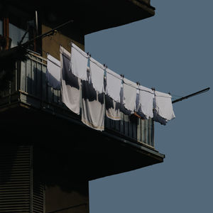 Low angle view of clothes drying against buildings