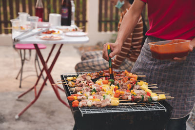 Man preparing food on barbecue grill