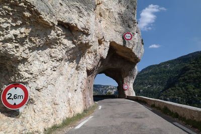 Road sign against sky