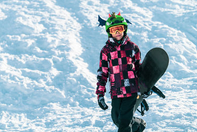 Portrait of boy with snowboard