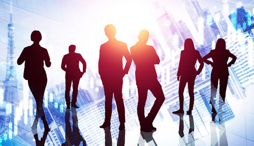 Silhouette people walking in modern office building