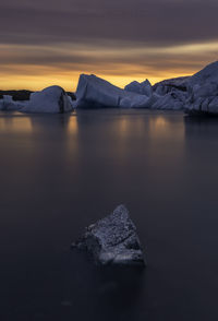 Scenic view of lake against sky during winter