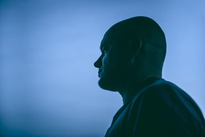 Close-up of man against blue sky