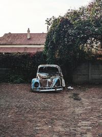 Vintage car on street against building