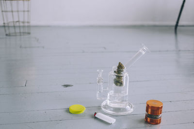 High angle view of medicine in grinder on hardwood floor