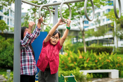 Kids playing on monkey bars at playground