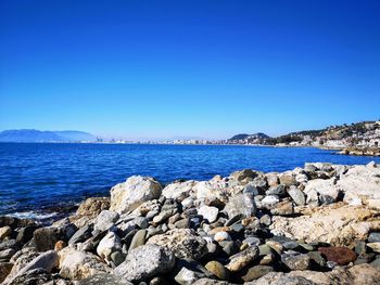 Scenic view of sea against clear blue sky