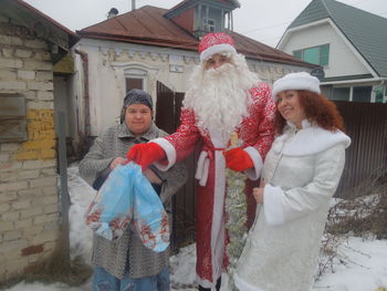 Portrait of smiling young woman standing in winter
