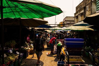 People walking at market stall in city