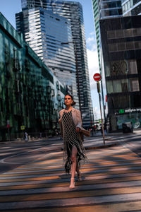 Rear view of woman walking on street in city