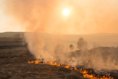 Scenic view of sunlight falling on land against bright sun