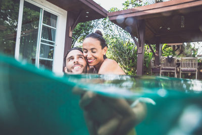 Portrait of a smiling young woman swimming pool