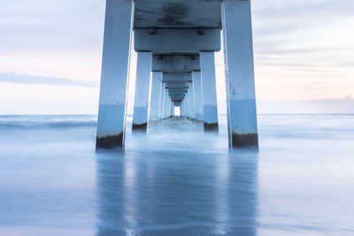 Pier over sea against sky