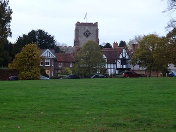 Buildings in lawn against sky