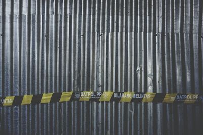 Close-up of yellow text on metal grate
