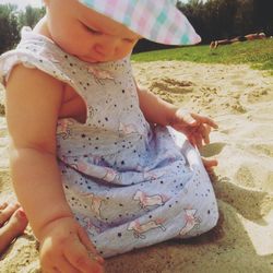 Low section of child playing with sand