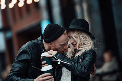 Young couple holding hat