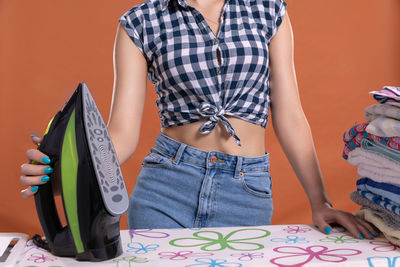 Midsection of woman holding book