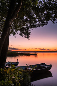 Scenic view of lake against sky at sunset