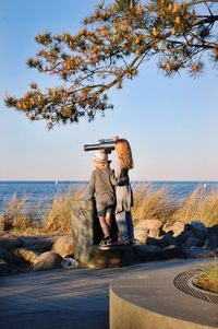 Man photographing while standing on beach