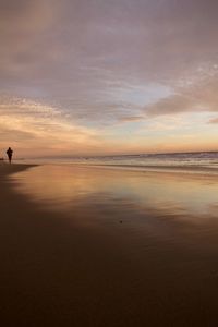 Scenic view of beach against sky during sunset